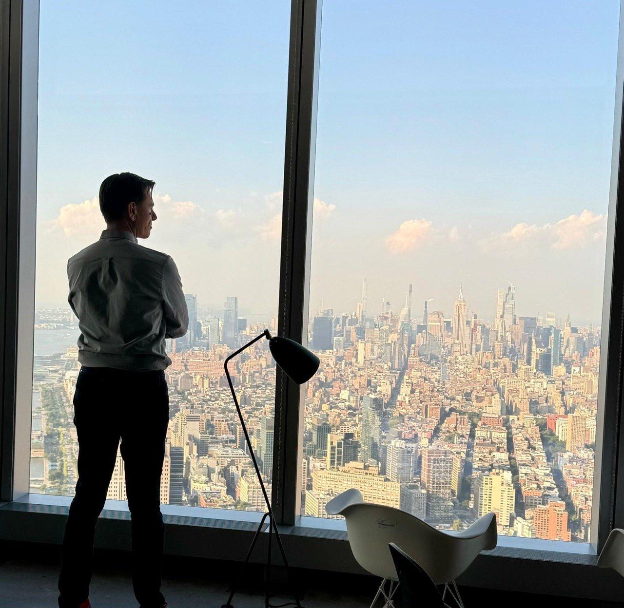 A person seen from behind, looking out over a city