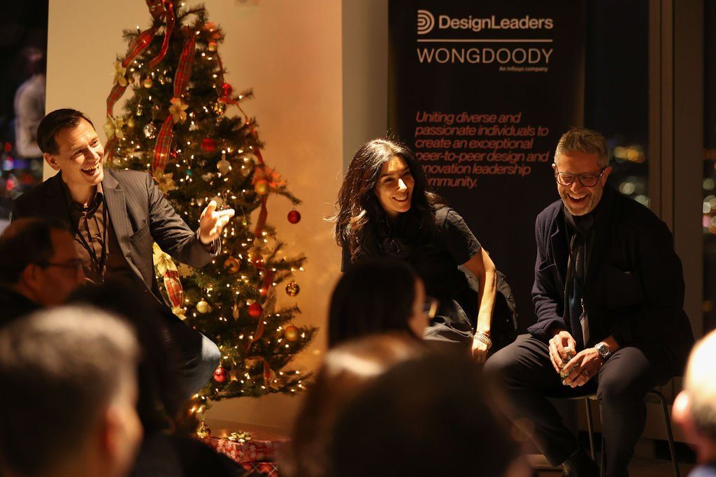 Panellists sharing a laugh during a Design Leaders fireside conversation