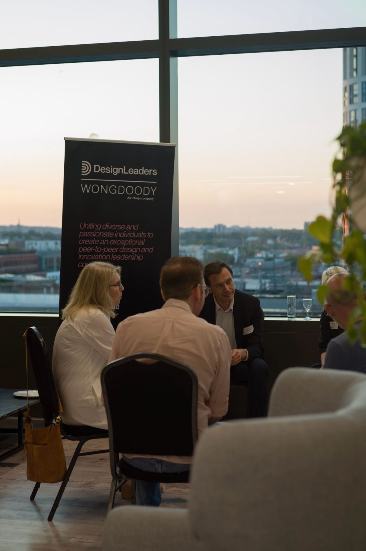 An event room with a Design Leaders banner and a view over the city
