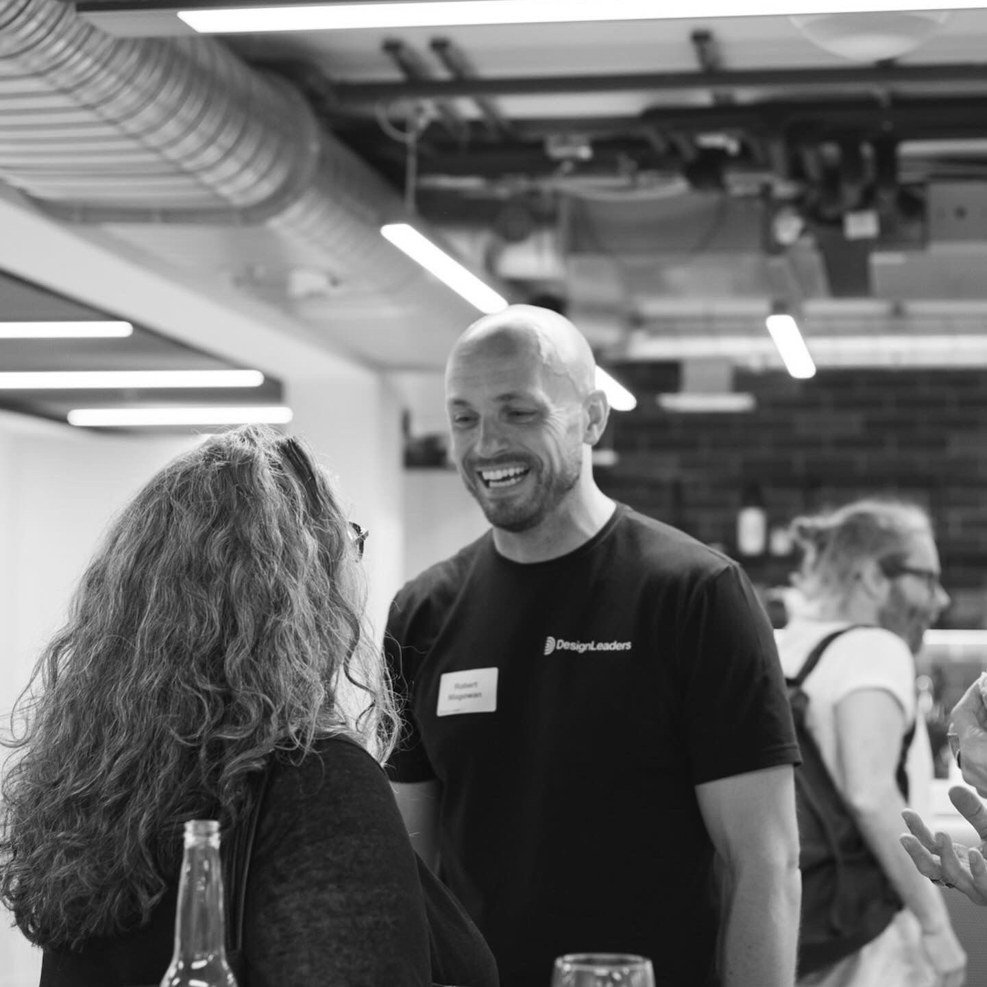 A member of the Design Leaders team laughing with guests