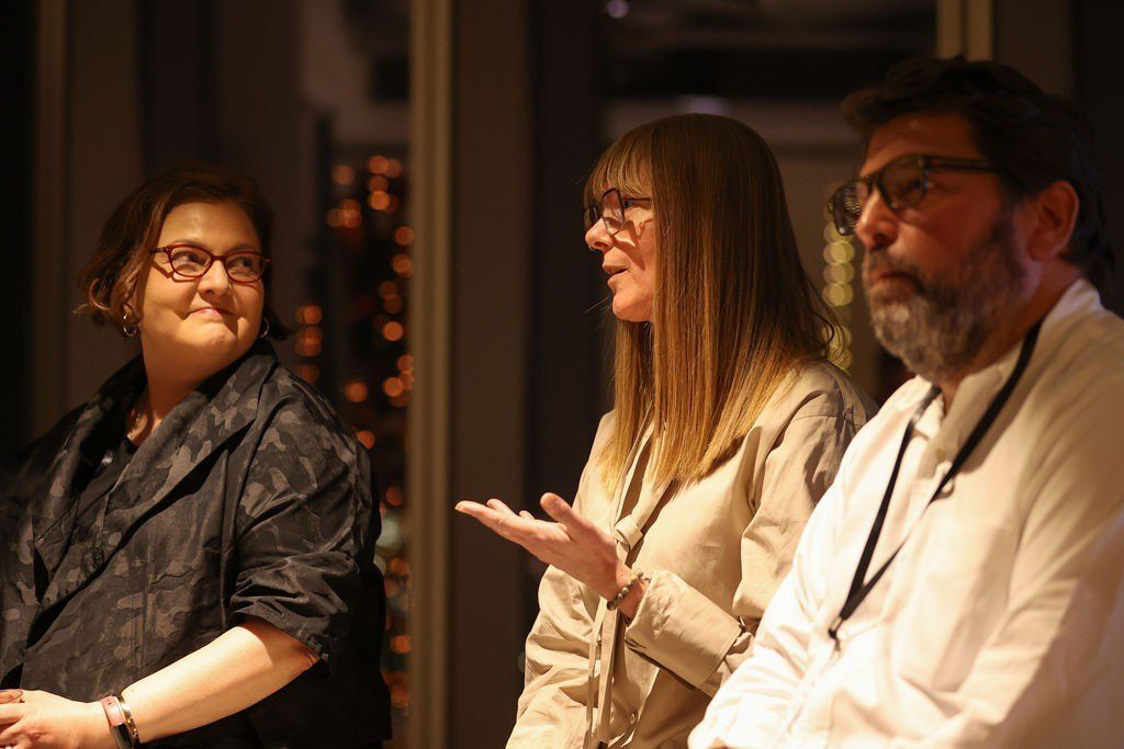 Three panellists in conversation at an evening Design Leaders event